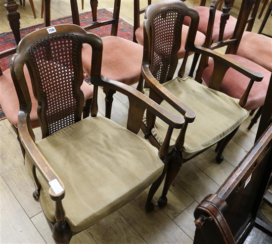 A pair of 1920s cane back elbow chairs